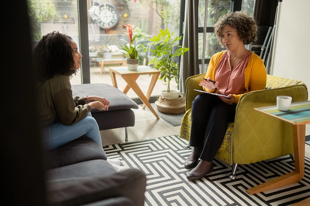 woman talking to a therapist about mental health issues